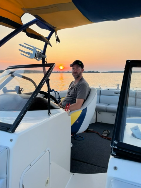 andy sitting in a boat